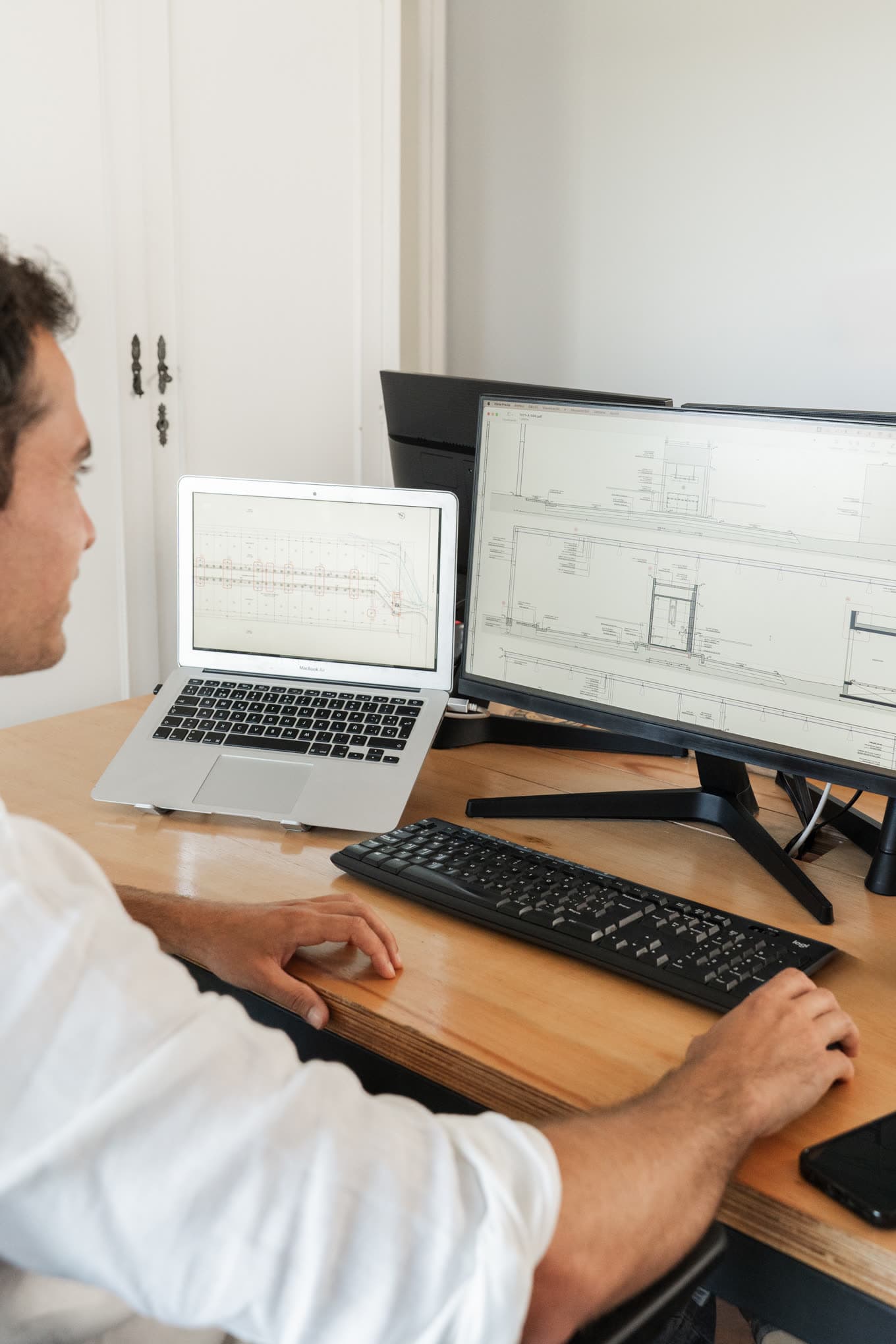 A construction drawing open on screen at the studio